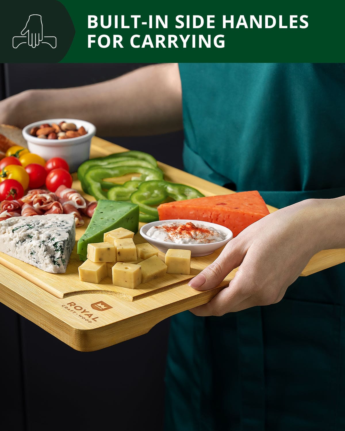 Person holding a wooden cutting board with food and text about built-in side handles.