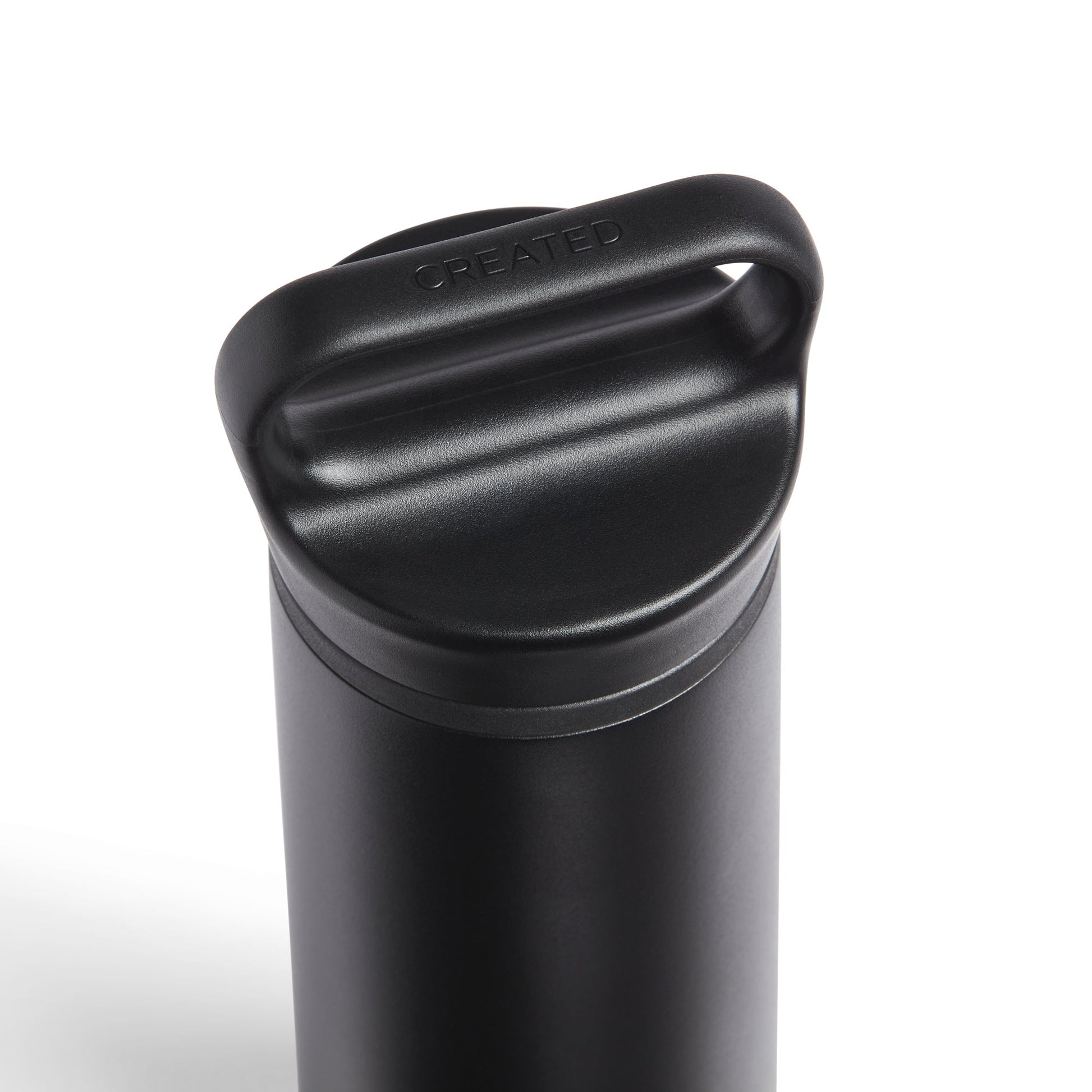 Black insulated drink container with a lid on a white background