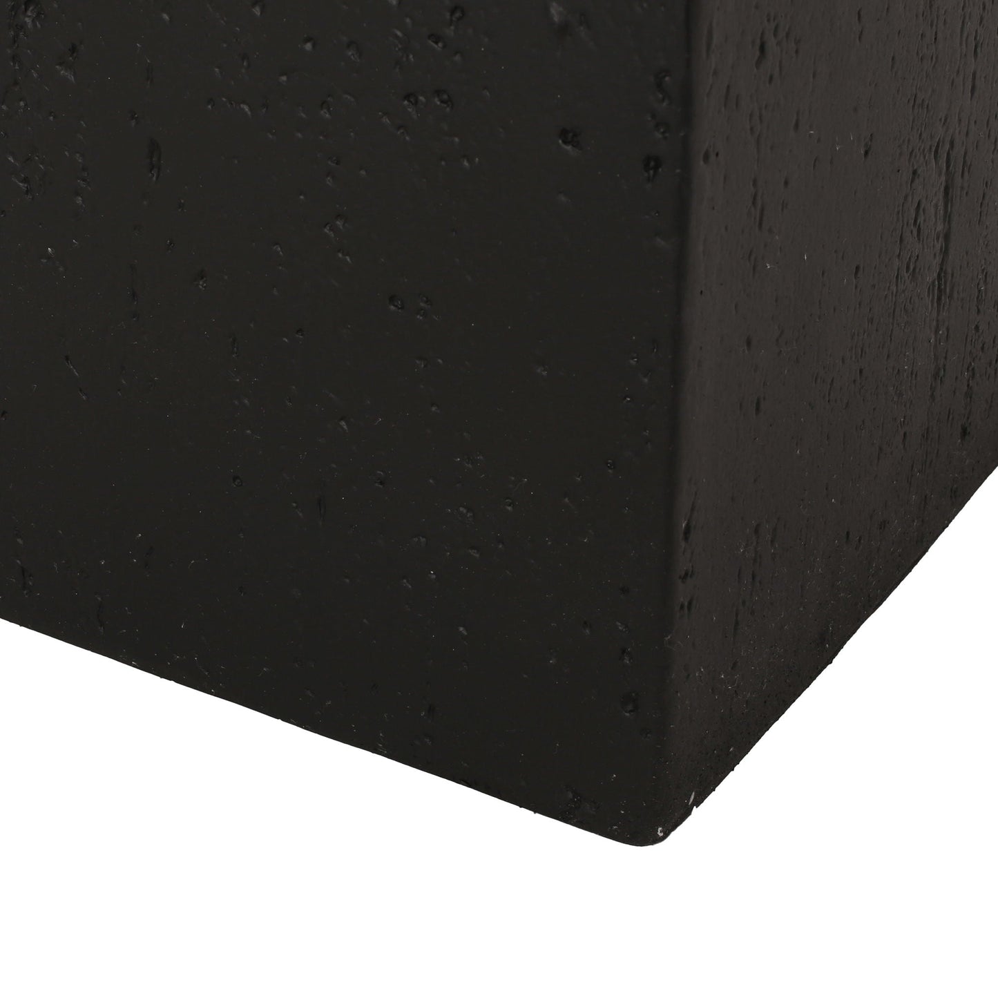 Close-up of a black concrete block corner
