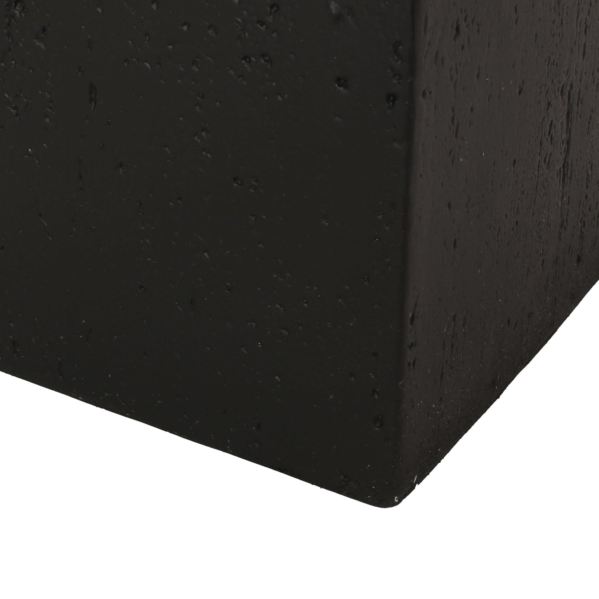 Close-up of a black concrete block corner