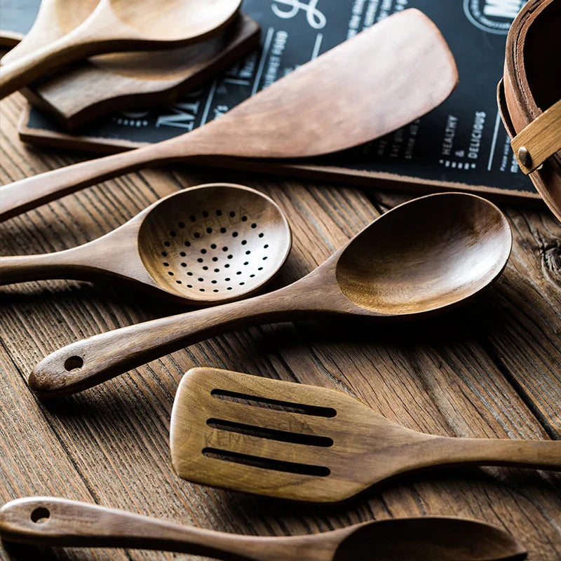 Set of wooden kitchen utensils on a wooden surface