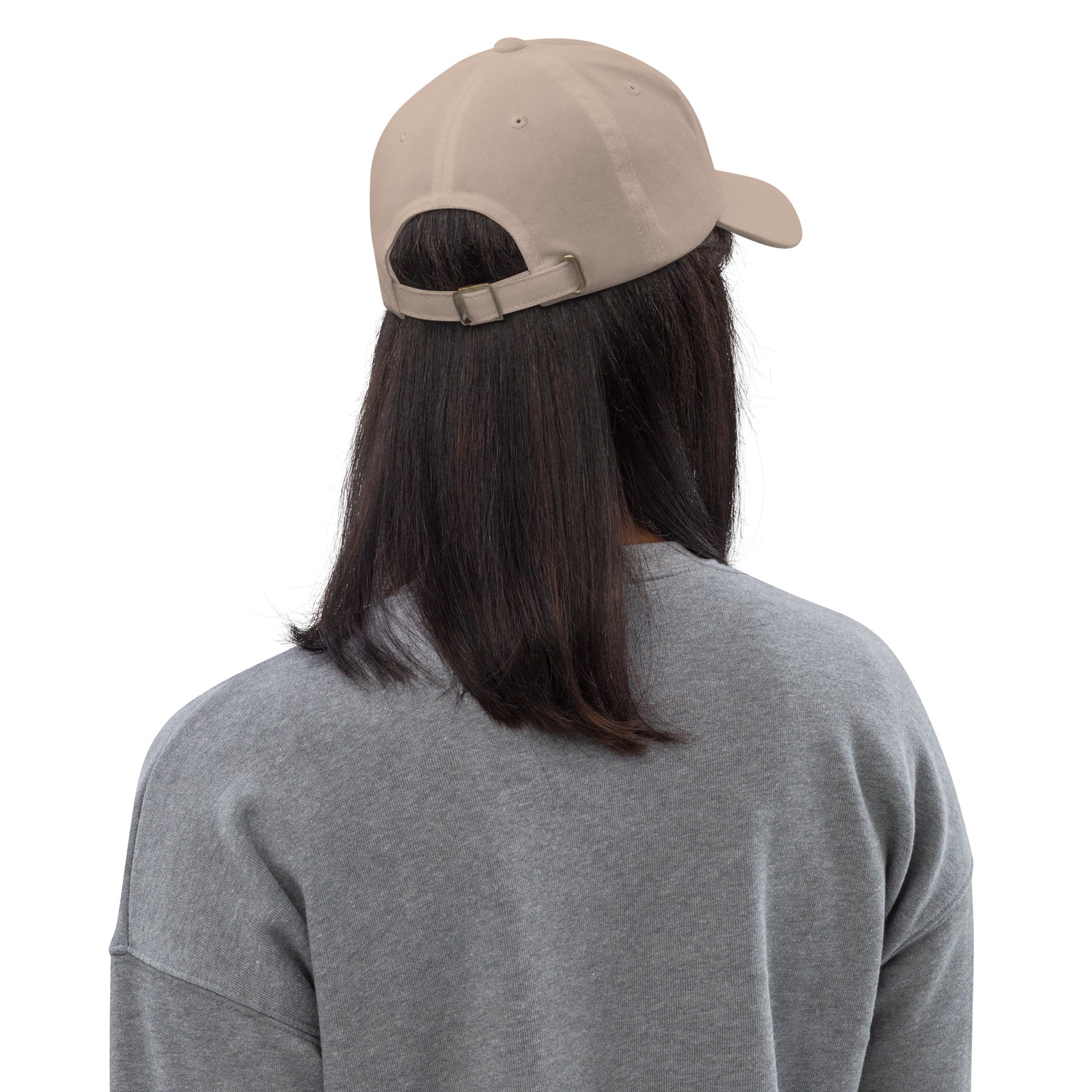 Person wearing a beige cap from behind on a white background
