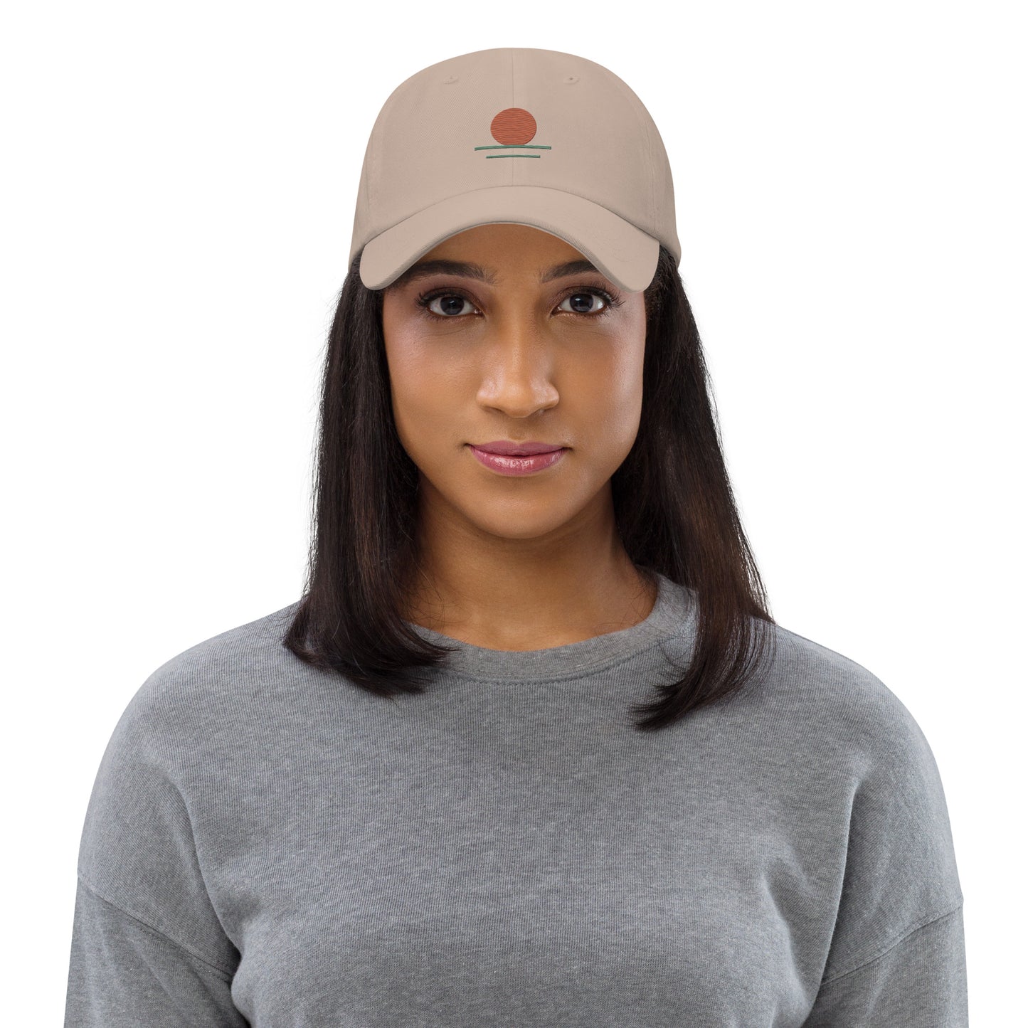 Woman wearing a beige cap with 'free' text on a white background