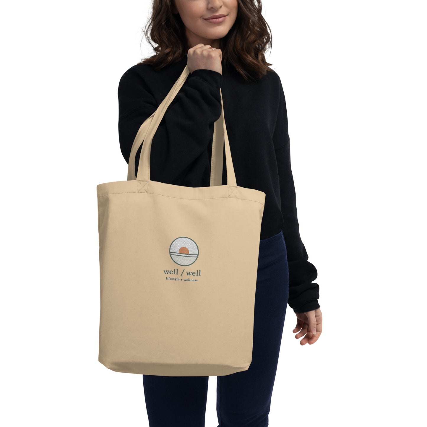 Person holding a beige tote bag with 'chomp chomp' text on a white background